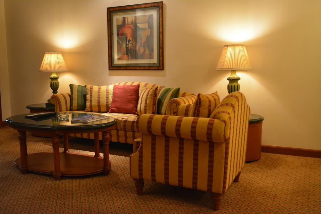 The Orchid Hotel Mumbai Vile Parle Екстериор снимка A living room with a sofa
